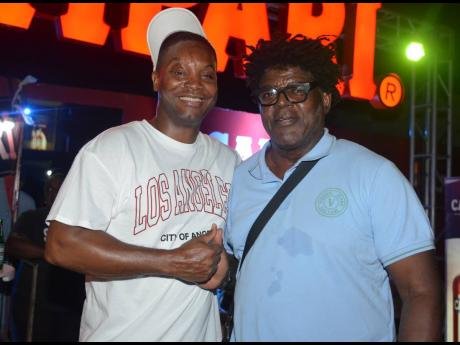 Troy Henry (left) takes a break from work to share lens time with his father Whitfield ‘Witty’ Henry, founder of Uptown Mondays.