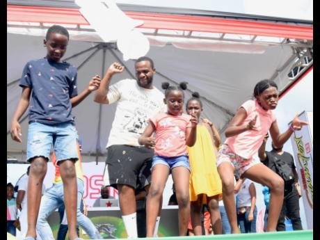 Dancehall artiste Teejay dancing on stage with some young fans to his trending song ‘Drift’ at the Reggae Sumfest Family Funday held at the Catherine Hall Stadium in Montego Bay last year.